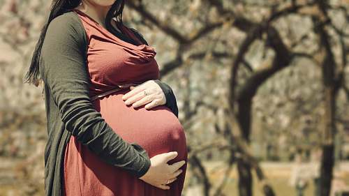 human pregnant woman holding her stomach people