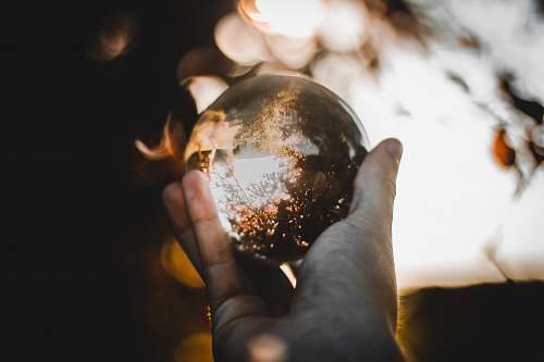 human selected focus of clear glass ball people
