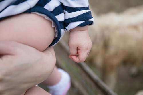 human selective focus photography of child finger