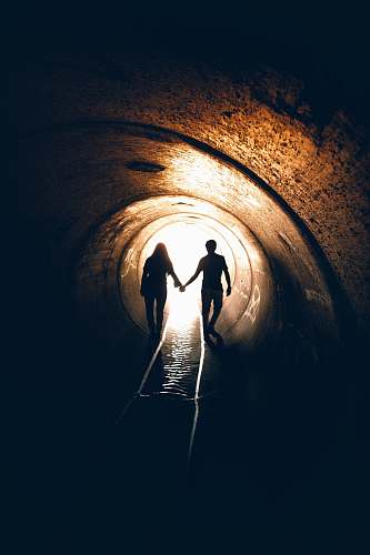 human silhouette of man and woman inside tunnel tunnel