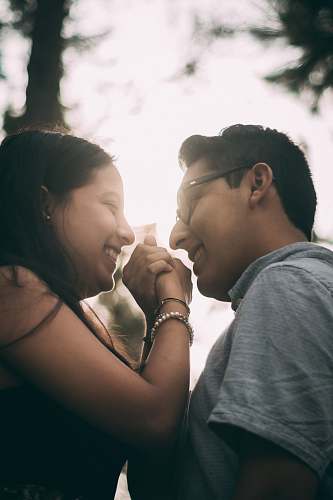 human smiling woman and man facing each other dating