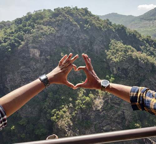 human two person forming heart shape by hands hand