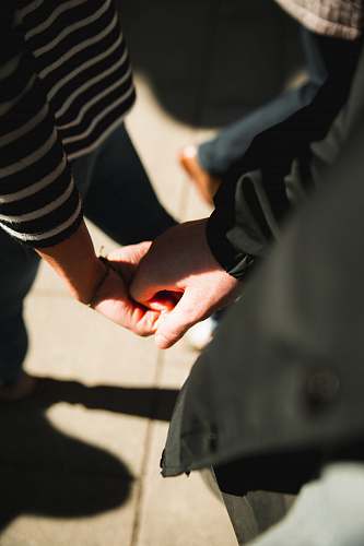 human two persons holding each other hands holding hands