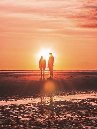 human two persons stands near shore nature