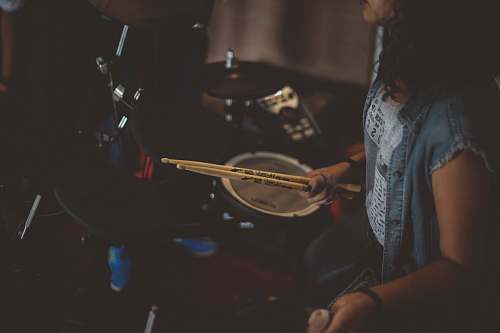 human woman carrying drums sticks people