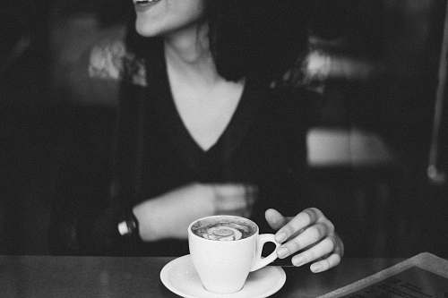 human woman holding coffee mug black-and-white