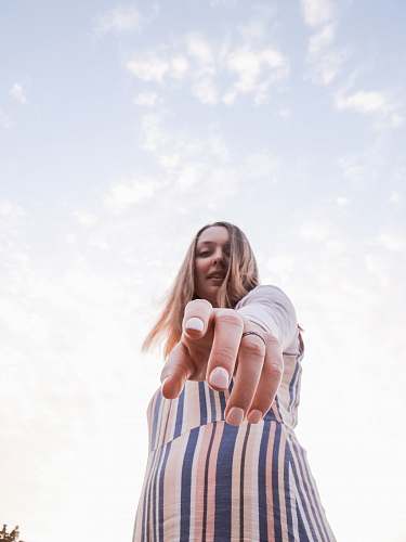 human woman in beige and blue striped dress face