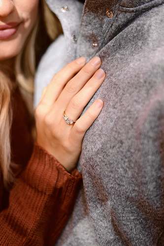 human woman leaning on person in gray top ring