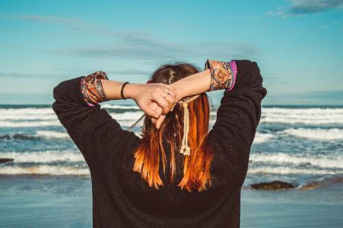 human woman standing by the seashore during daytime hand