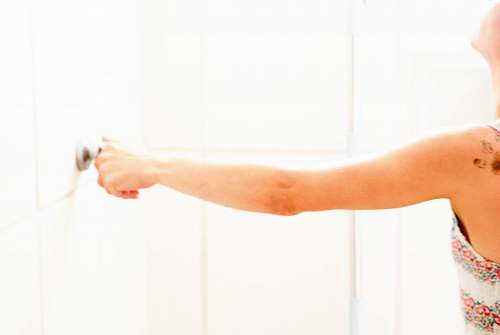 human woman touching door knob arm
