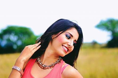 girl woman wearing pink sleeveless tops projecting while smiling selective photography woman