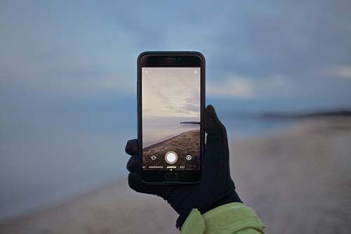 iphone person black smartphone taking picture glove