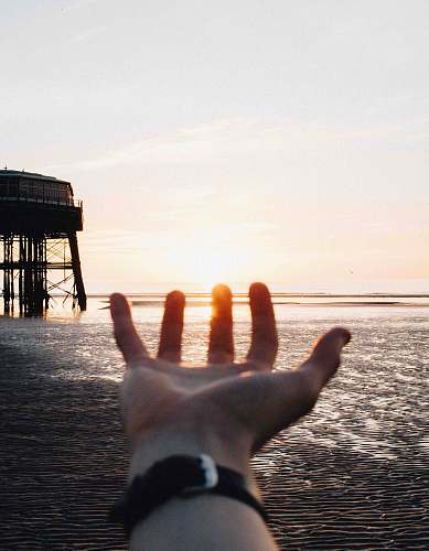 dock person showing left hand near body of water blackpool