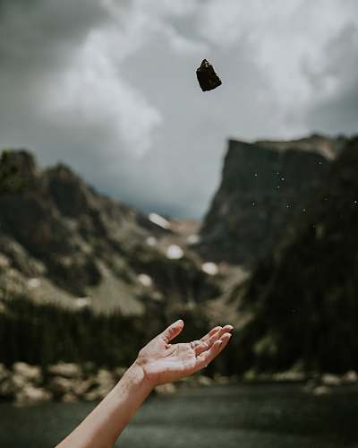 rock person threw stone during daytime stone