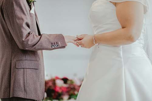 wedding woman holding hands with man in front of altar flora
