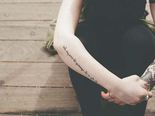 hand human hand with black tattoes arm