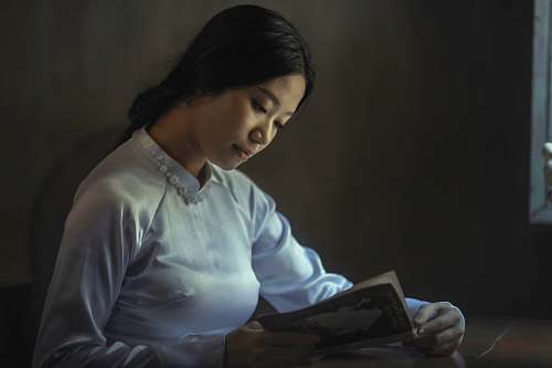 people woman wearing gray long-sleeved tops reading book reading