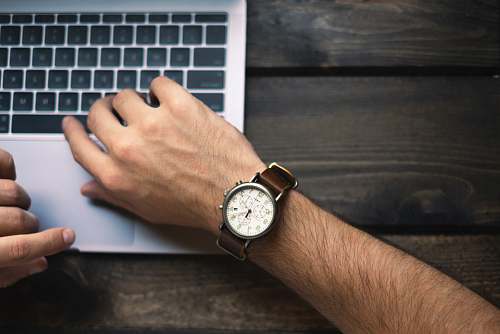 work person wearing brown and white watch hand
