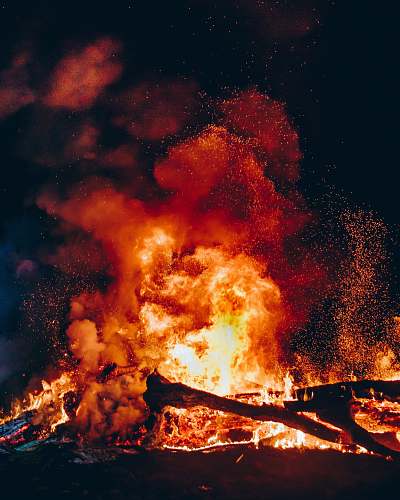 person fire with black smoke during night human