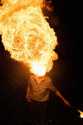 flame man spitting fire orange