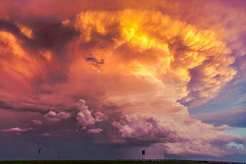 sky plume of orange clouds at sunset weather