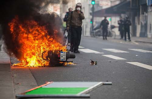 human motorcycle burning in the middle of the road asphalt