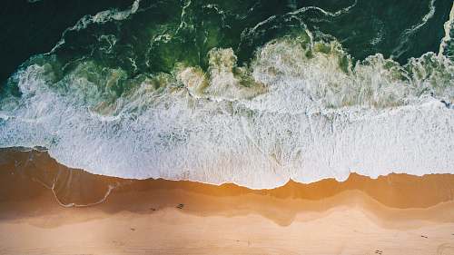 drone aerial photo of ocean waves foam