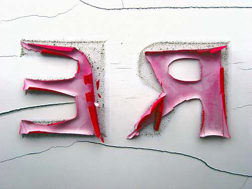 text closeup photo of a R and E stickers re