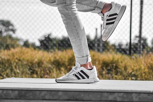clothing person wearing white adidas sneakers shoe