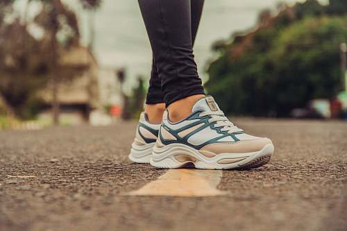 clothing person wearing white-and-gray sneakers footwear