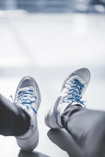 clothing selective focus photography of person wearing white Chuck Taylor Converse sneakers footwear