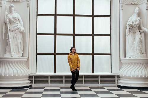 clothing woman wearing yellow hooded jacket and black pants human