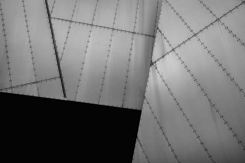 black-and-white Black and white shot of bolted metal architecture lying at angles manchester