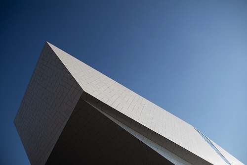 triangle low angle photography of building blue