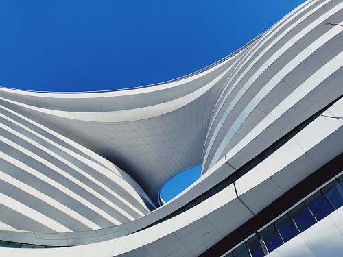 building low angle photography of building under blue sky blue