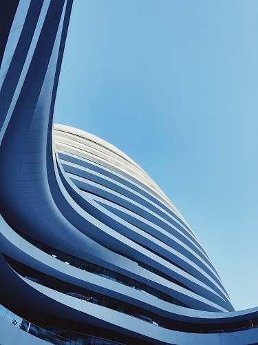 building low-angle photography of state of the high-rise building under blue calm sky blue