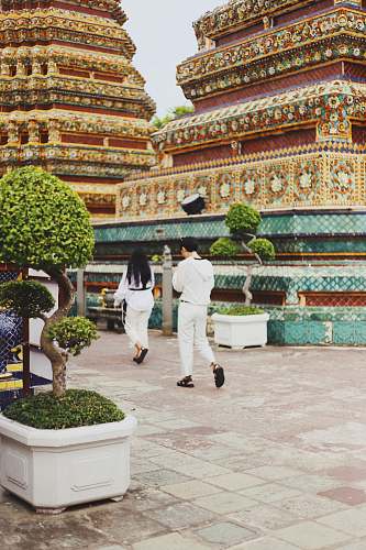 building man and woman in white going to temple temple