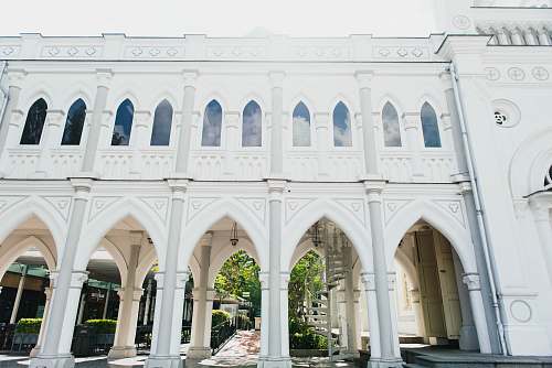 building white concrete building with pillar columns arch
