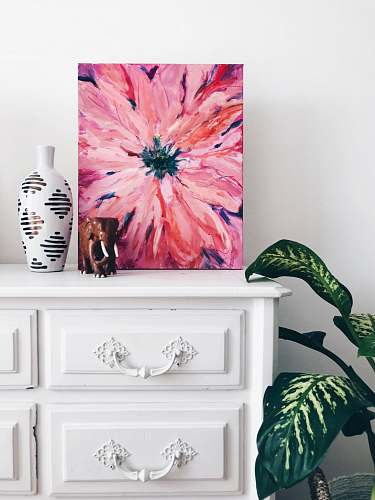 interior painting of pink flower on dresser near white vase home