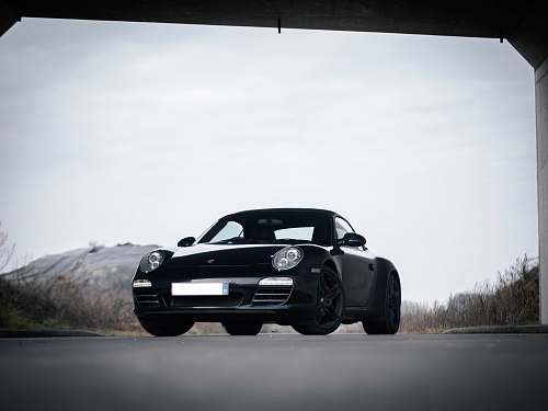 car black coupe on gray road during daytime transportation
