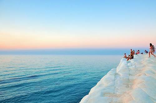 people group of people sitting on white limestone summer