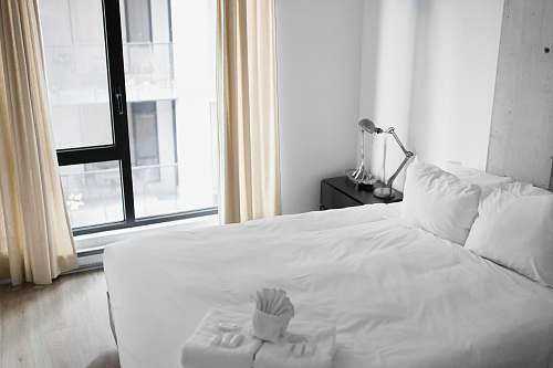 furniture vacant white bed near the window room
