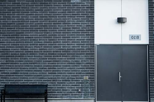 wall black metal bench brick