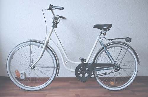 bike white cruiser bike on brown parquet floor mountain bike