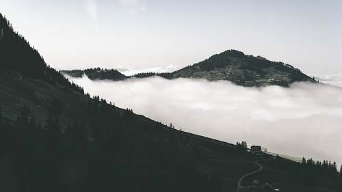 nature aerial photo of mountain and sea of clouds outdoors