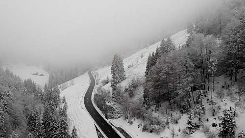 grey areal photography of roadway covered with snow switzerland