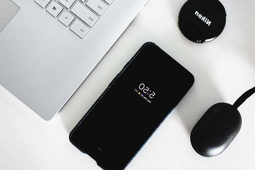 phone black Android smartphone beside grey laptop computer computer