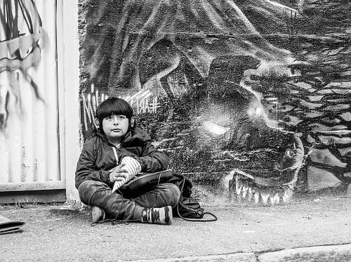 human boy sits on the street person