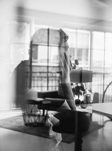 person double exposure photo of man and black Ottoman chair human
