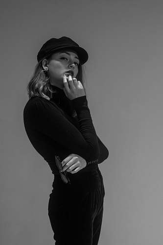 apparel gray scale photo of woman holding her mouth clothing